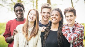 Five young teenagers smiling together