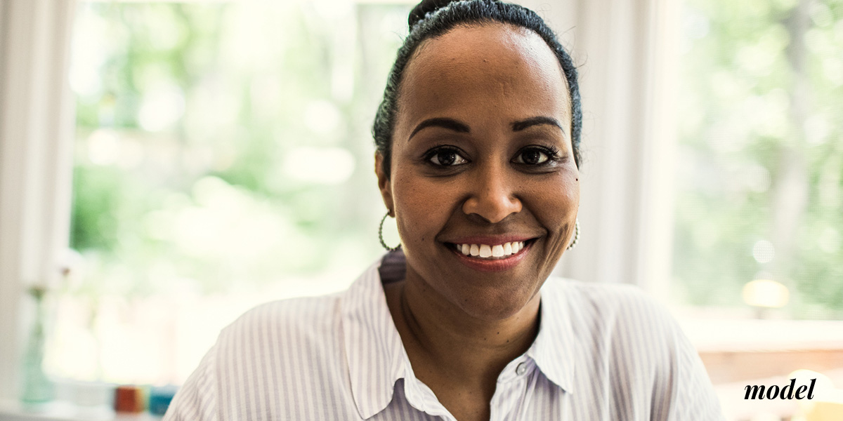 Female in Dress Shirt Smiling Broadly