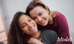 Mom and Teenage Daughter Smiling and Hugging