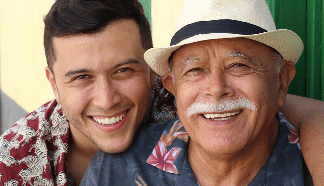 Young man with arms around his grandfather   sf oral surgery